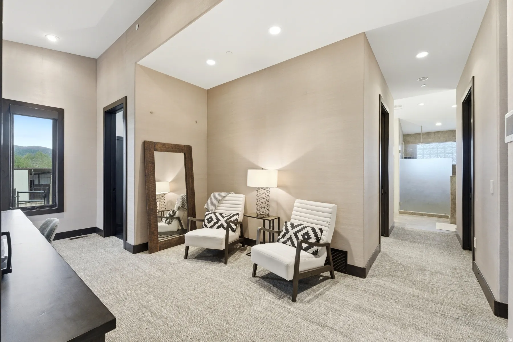 Carpeted hallway featuring recessed lighting and dark wood trim