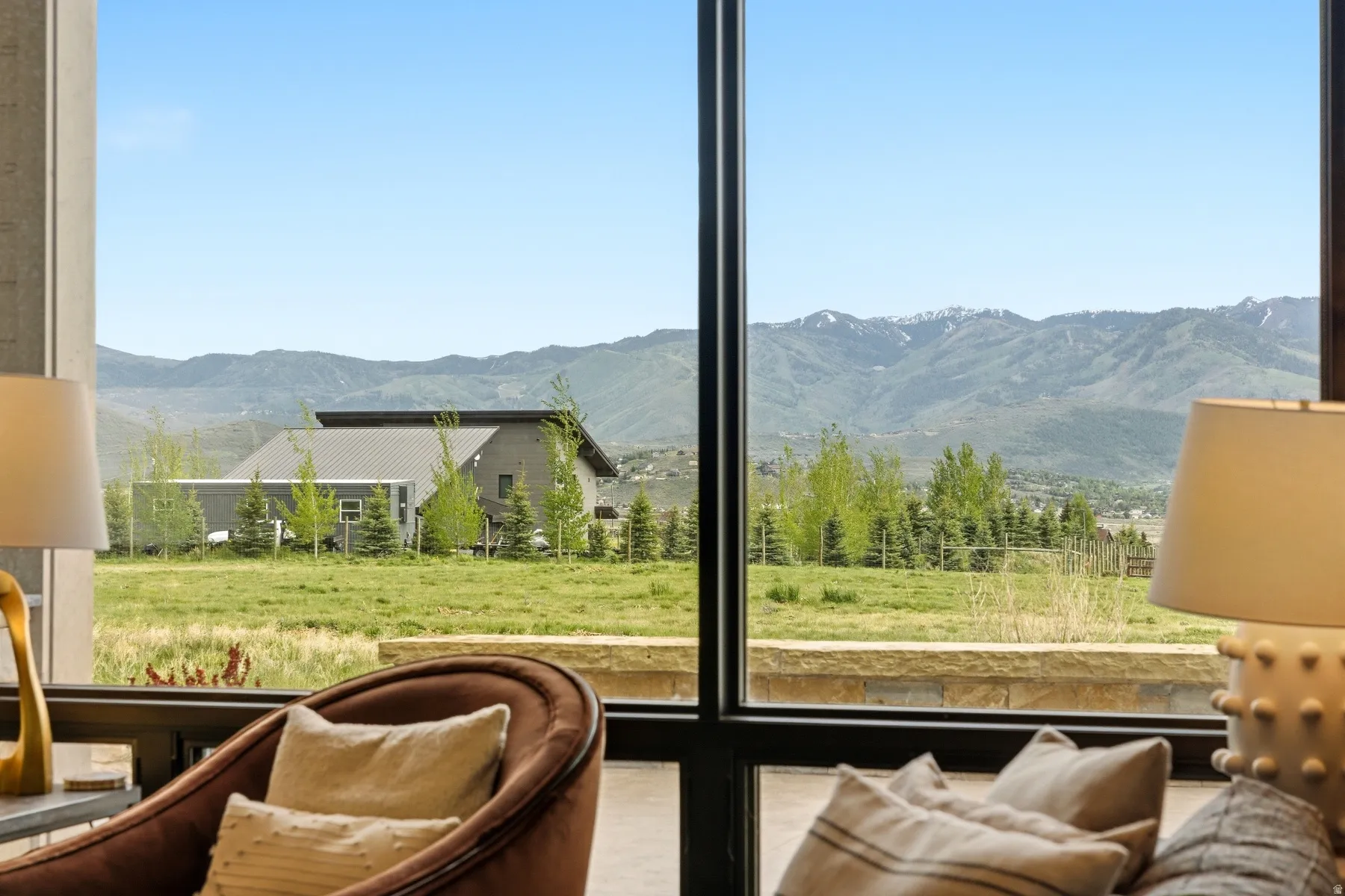 Expansive window framing distant mountains with snow-capped peaks