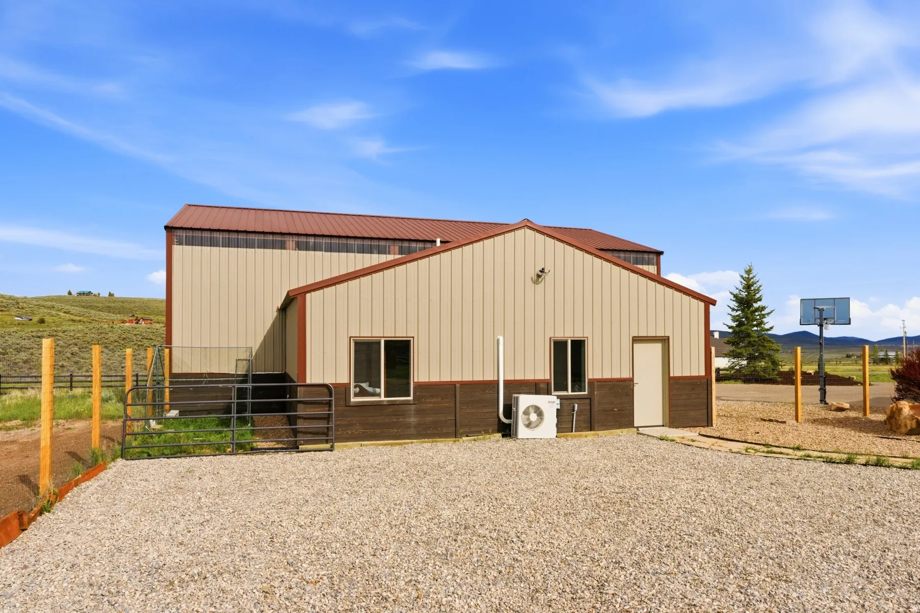 Metal structure featuring a tan upper facade, brown lower facade, and a complementary brown roof