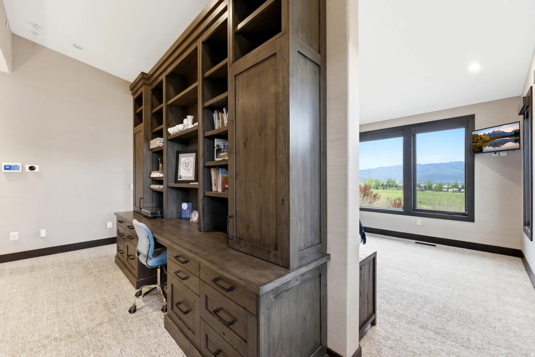 Built-in wood-finish cabinetry featuring open shelving and integrated desk space