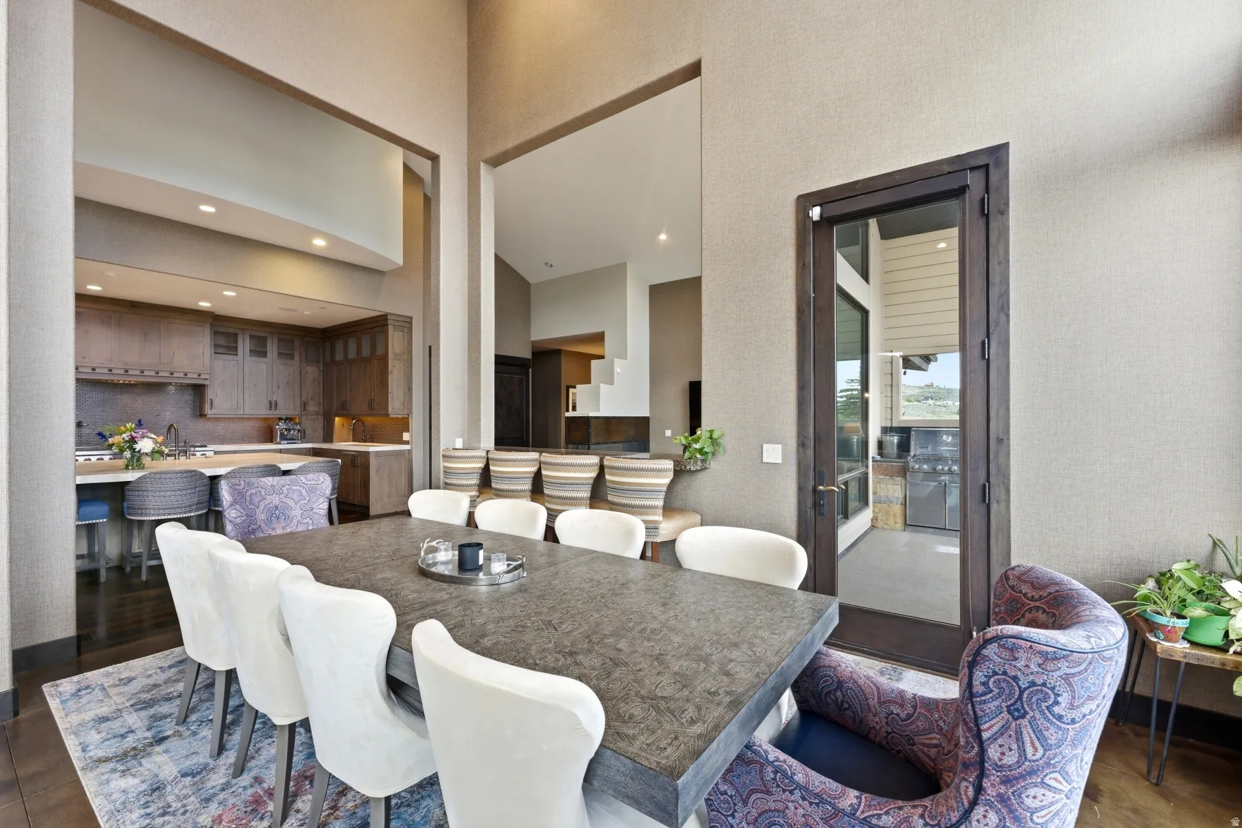 Open-concept dining area with wood-finish flooring and textured wall finishes