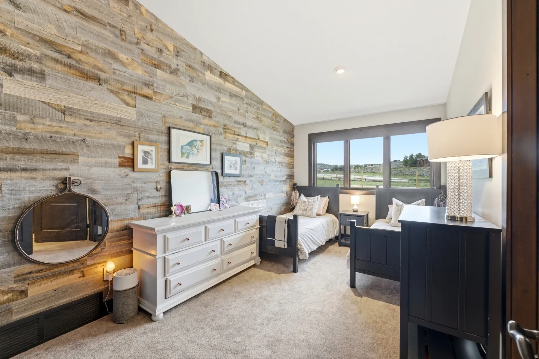 Accent wall featuring plank wood-finish detailing, large window with expansive outdoor scenery, recessed lighting, and soft carpeting