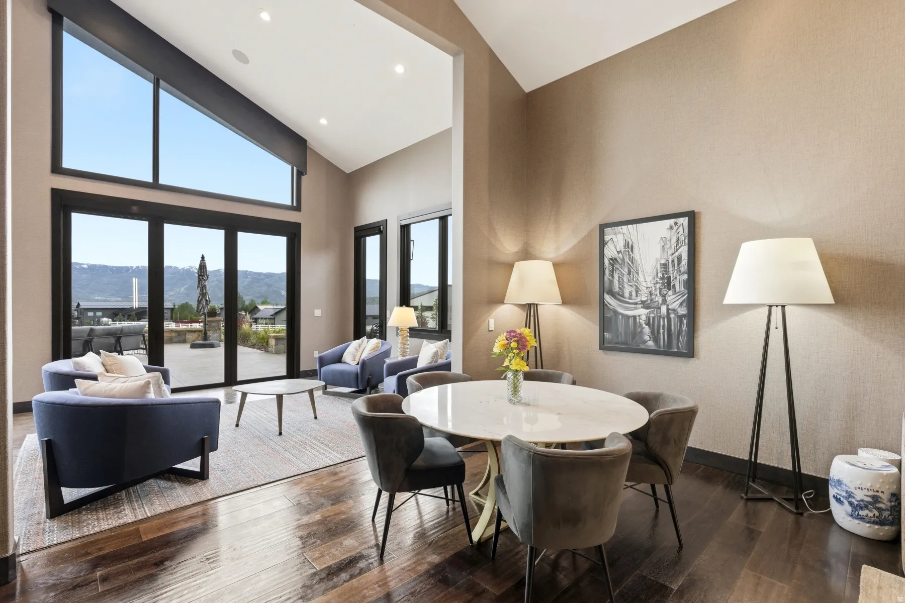 Vaulted ceilings with recessed lighting over rich wood-finish flooring