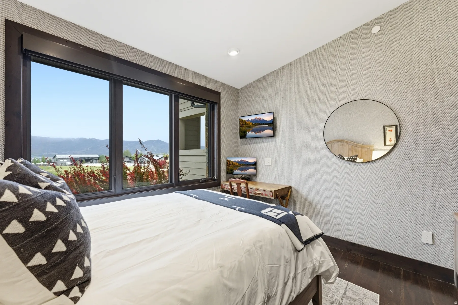 Dark-framed windows offering a mountainous landscape