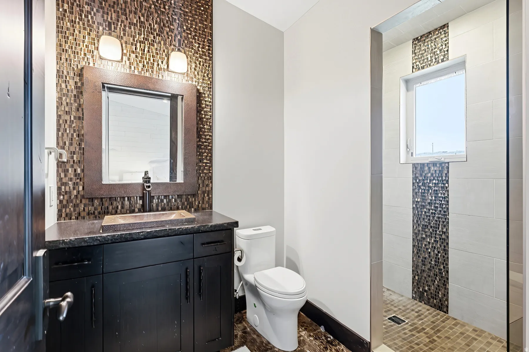 Bathroom featuring a dark wood-finish vanity with a dark countertop and a rectangular vessel sink
