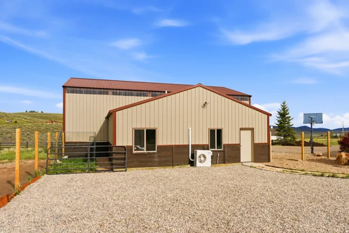 Metal structure featuring a tan upper facade, brown lower facade, and a complementary brown roof