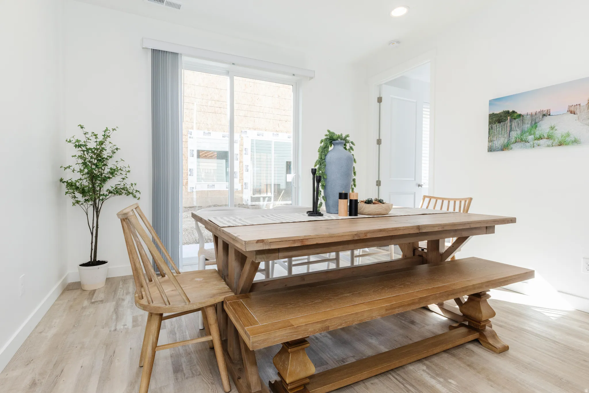 Open concept room featuring wood-finish flooring, white walls, and recessed lighting