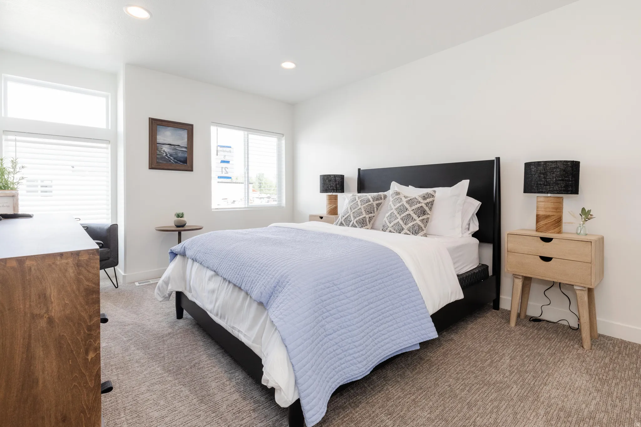 Bedroom featuring light-colored carpeting and bright white walls