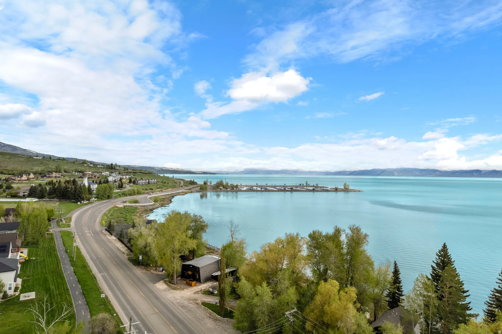 Expansive turquoise lakefront with surrounding natural landscape