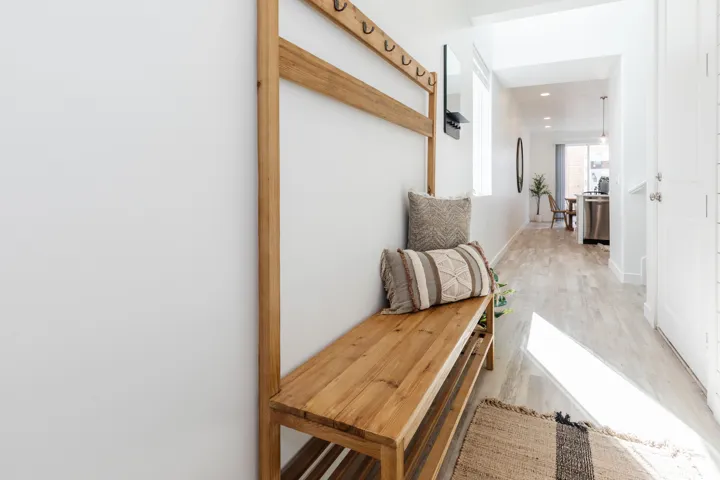 Hallway featuring light wood-finish flooring, white walls, and recessed lighting
