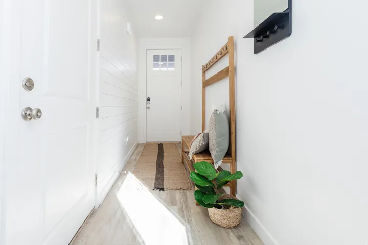 Entryway featuring crisp white walls, wood-finish flooring, recessed lighting, and a front door with divided lites