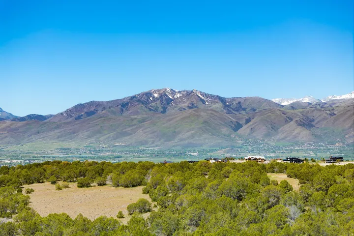 Mountain range backdrop featuring snow-capped peaks and expansive natural landscaping