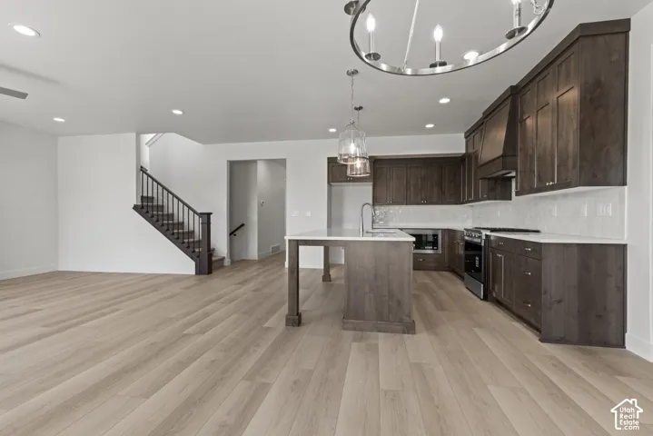 Expansive open-concept living area featuring light wood-finish flooring