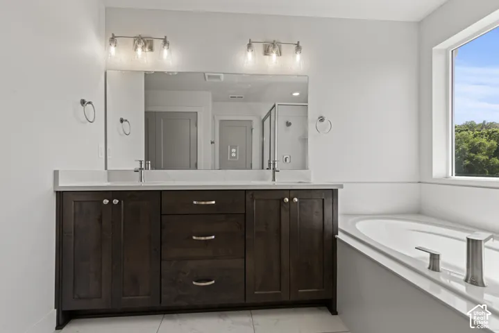 Spacious bathroom featuring a double vanity with dark wood cabinetry and a white countertop