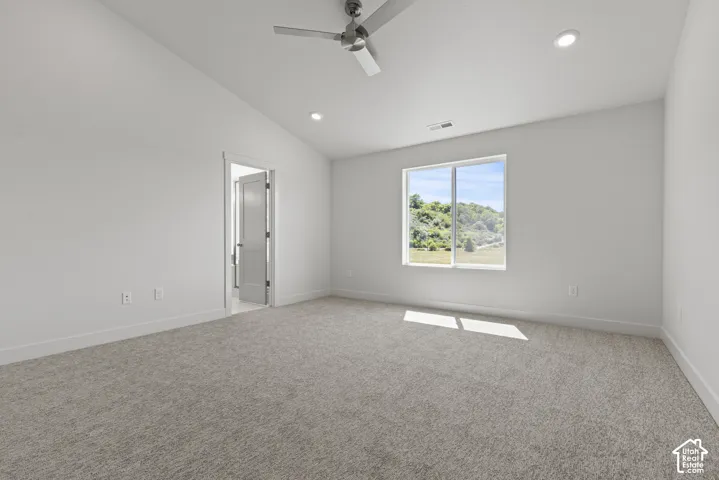 Neutral-toned carpet flooring in a room with a large window