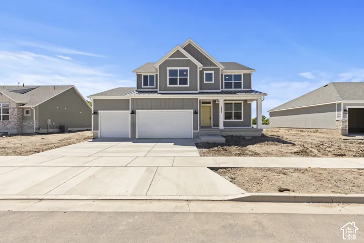 Contemporary two-story residence with a gray siding exterior and white trim accents