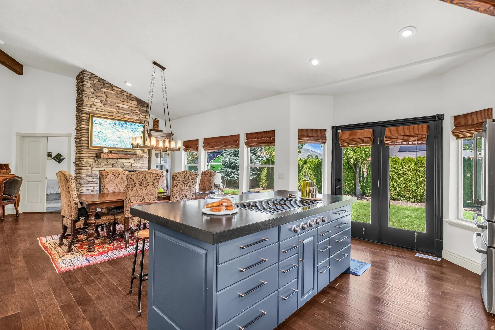 Gourmet kitchen island with a built-in range and gray cabinetry