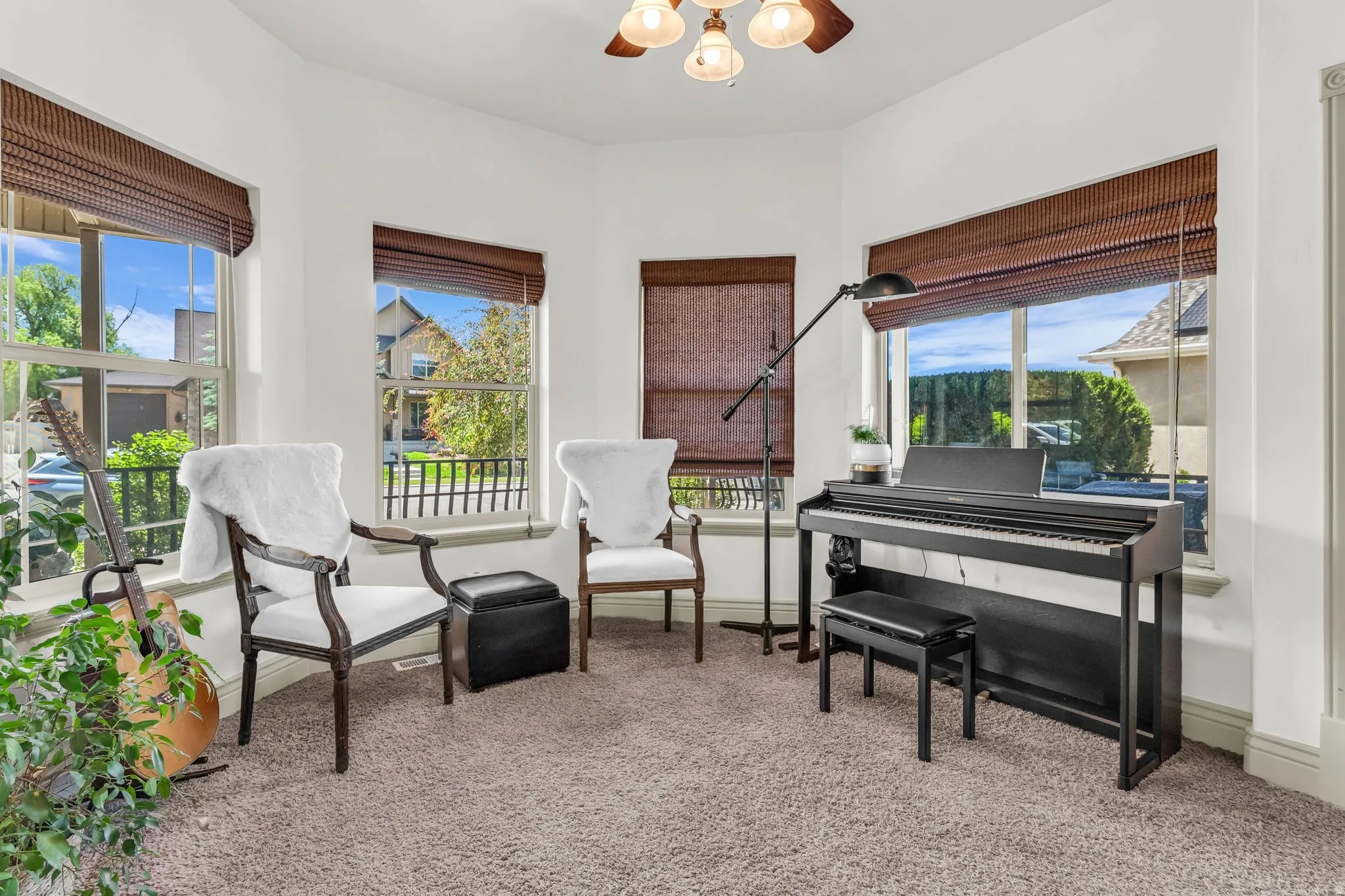 Flex Room that can be used as an office space, bedroom or entertainment room. Bay window alcove featuring multiple sash windows with woven wood blinds, creating a naturally illuminated space