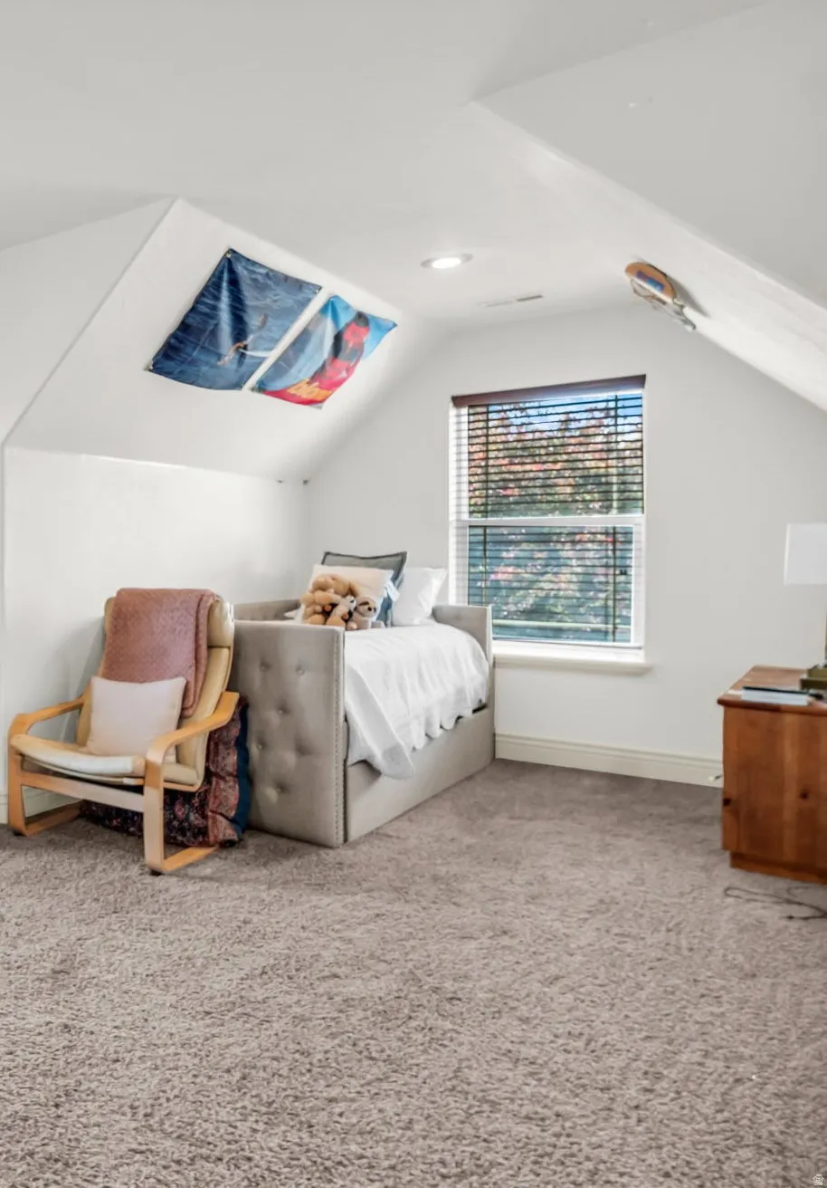 Attic space spacious 3rd  bedroom  featuring sloped ceilings, recessed lighting, a window with blinds, and neutral carpeting