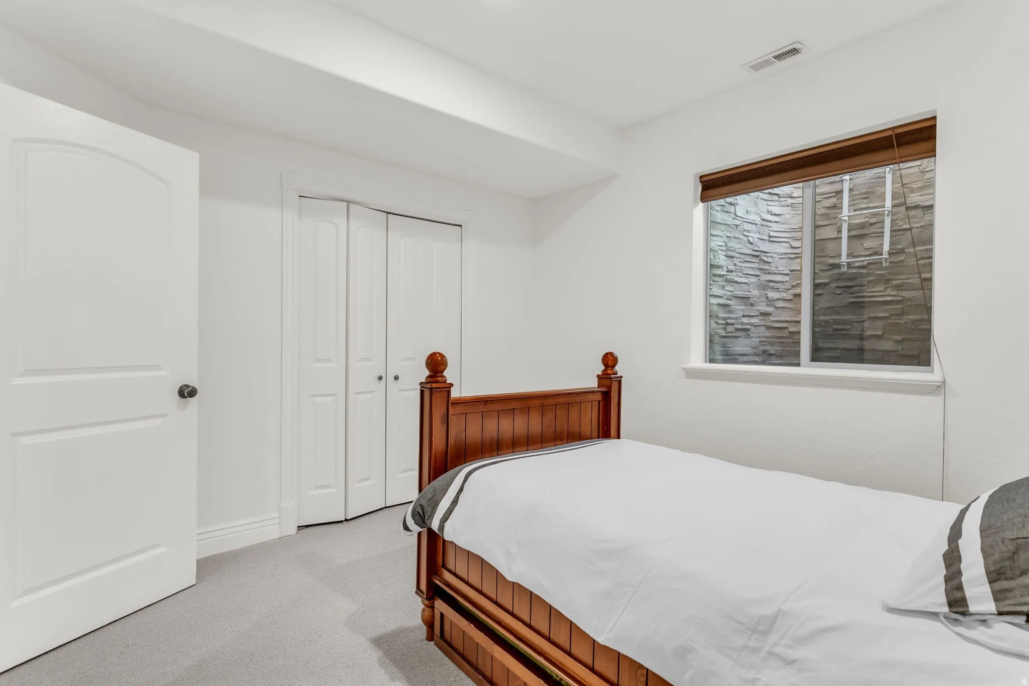 5th Bedroom featuring light toned walls with recessed lighting and carpet flooring with bifold closet