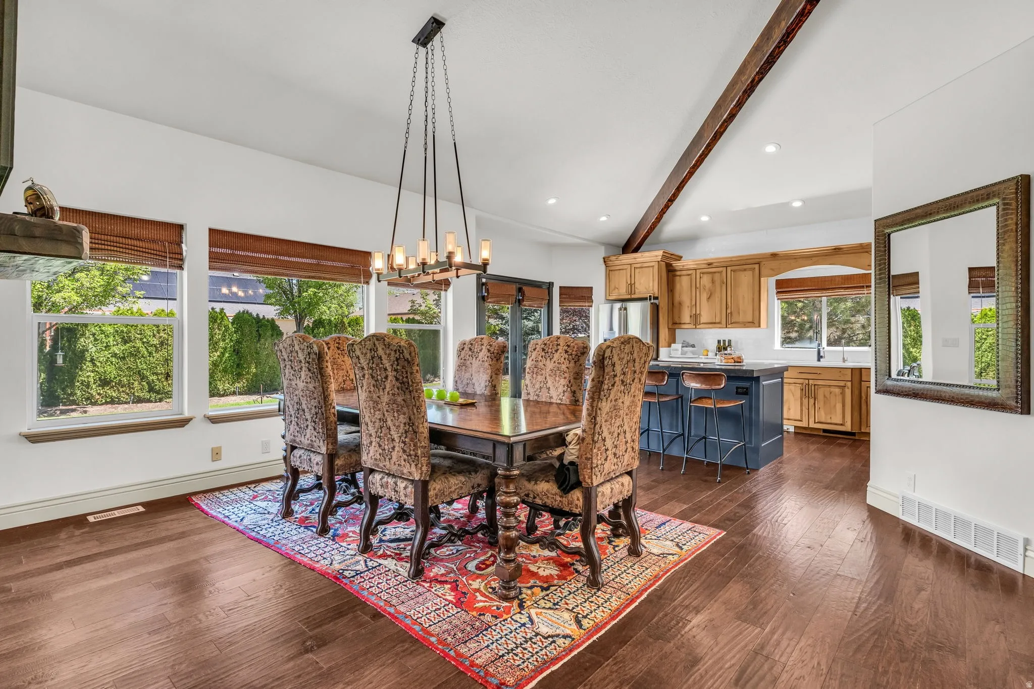 Spacious interior featuring rich wood-finish flooring and vaulted ceilings with exposed beams