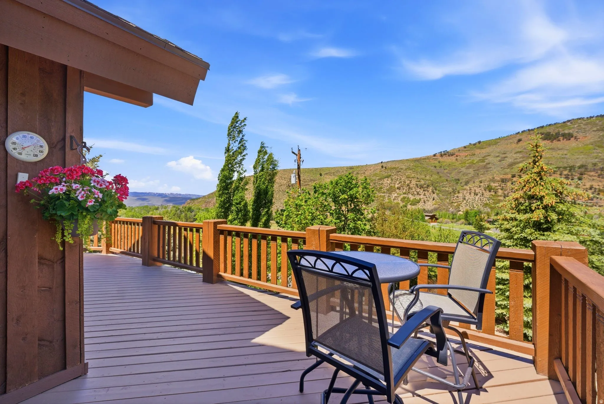 Expansive deck featuring wood-look decking and wood railing