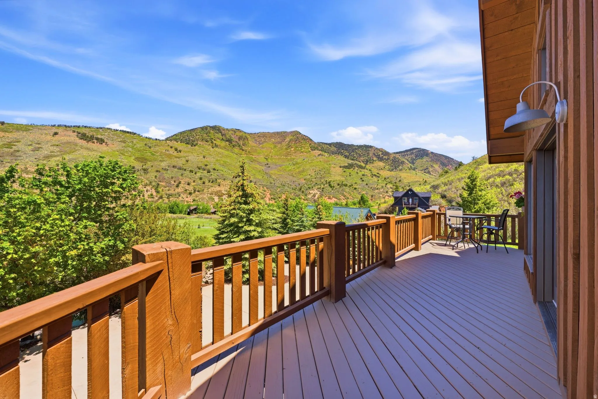 Expansive outdoor deck featuring composite decking and a natural wood railing