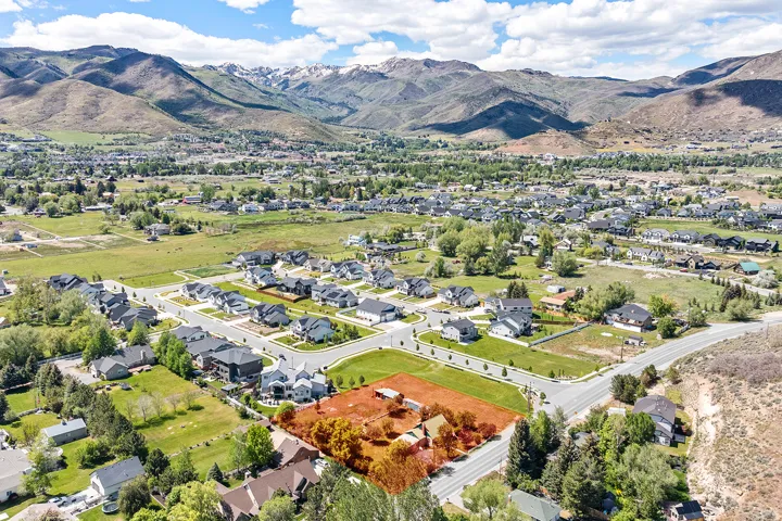 Aerial perspective showcasing a residential area set against a mountainous backdrop