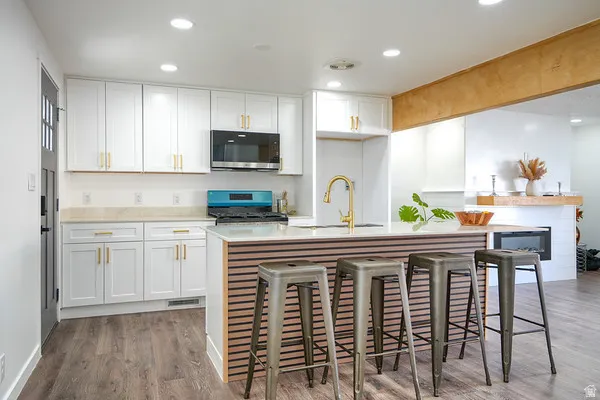 Modern kitchen with white cabinetry and gold-finish hardware