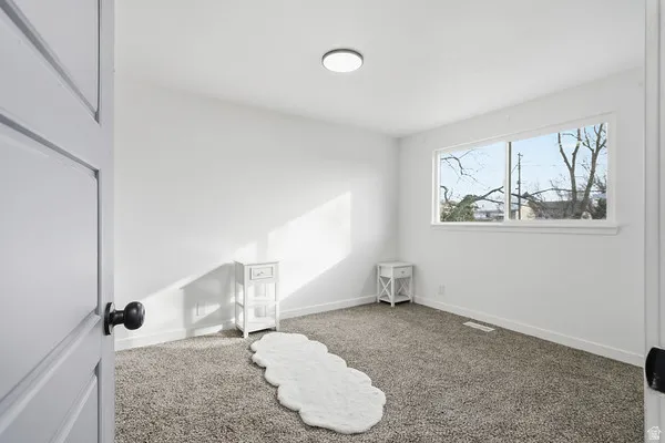 Neutral white walls with a flush-mount ceiling light
