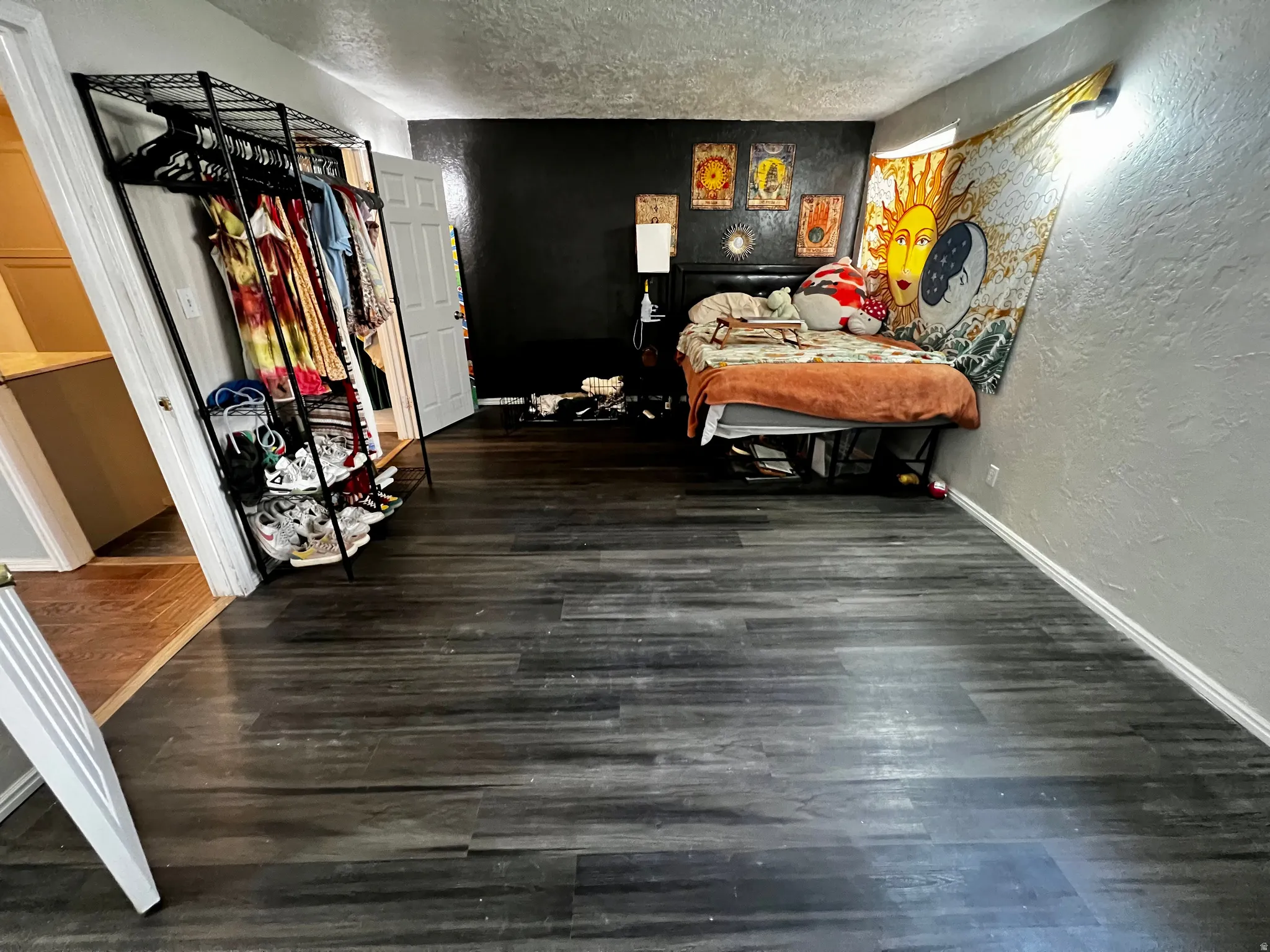 Dark wood-finish flooring extending throughout the room