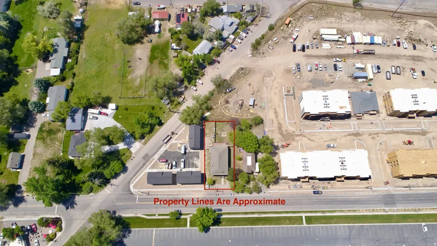Aerial perspective of the property, outlined in red, featuring a single-story structure with a dark roof
