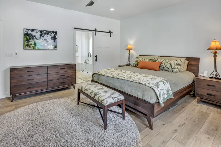 Light LVP flooring complements a dark wood-finish bed frame and dresser