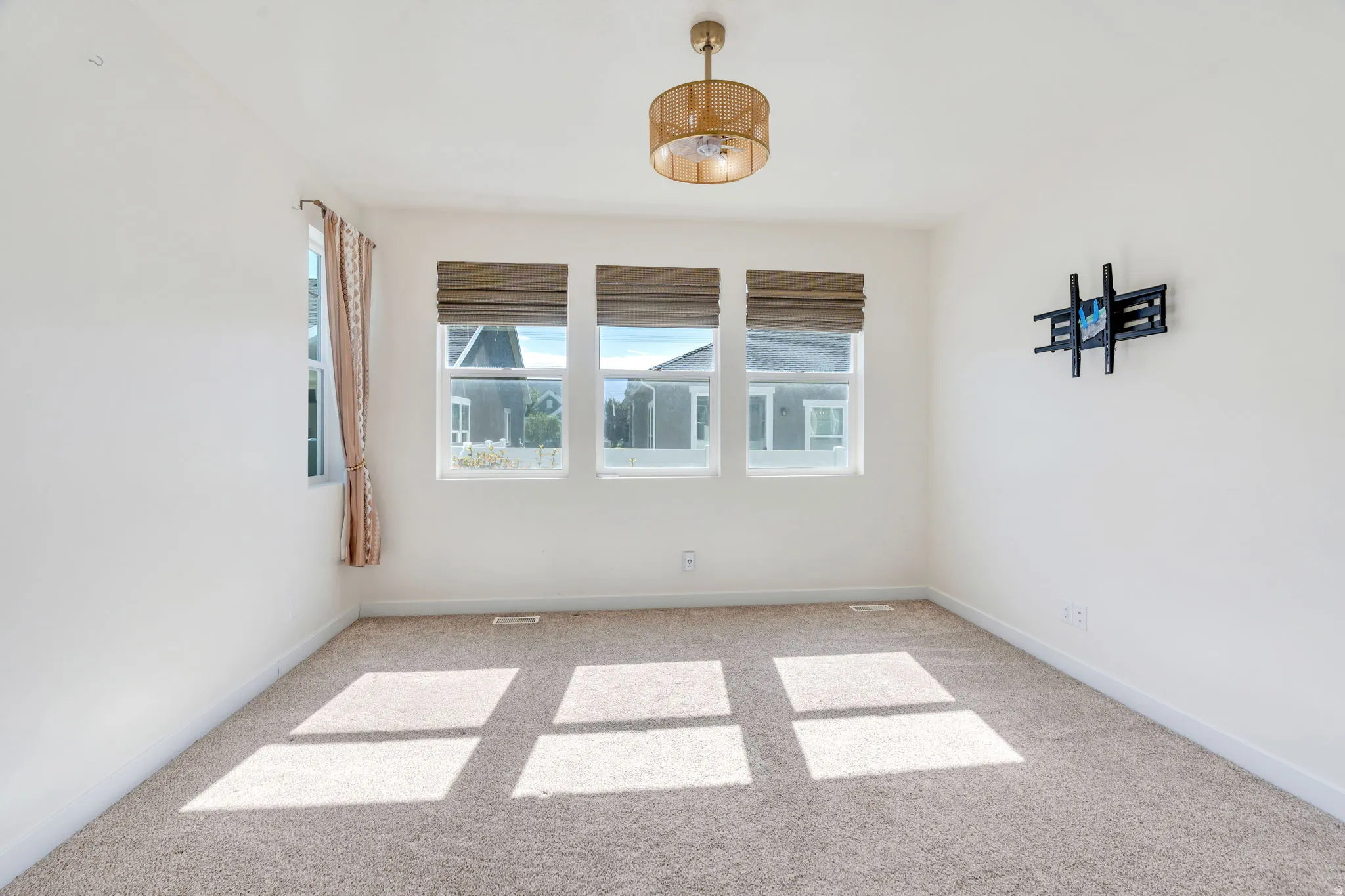 Bright interior space featuring light-colored carpeting and white walls