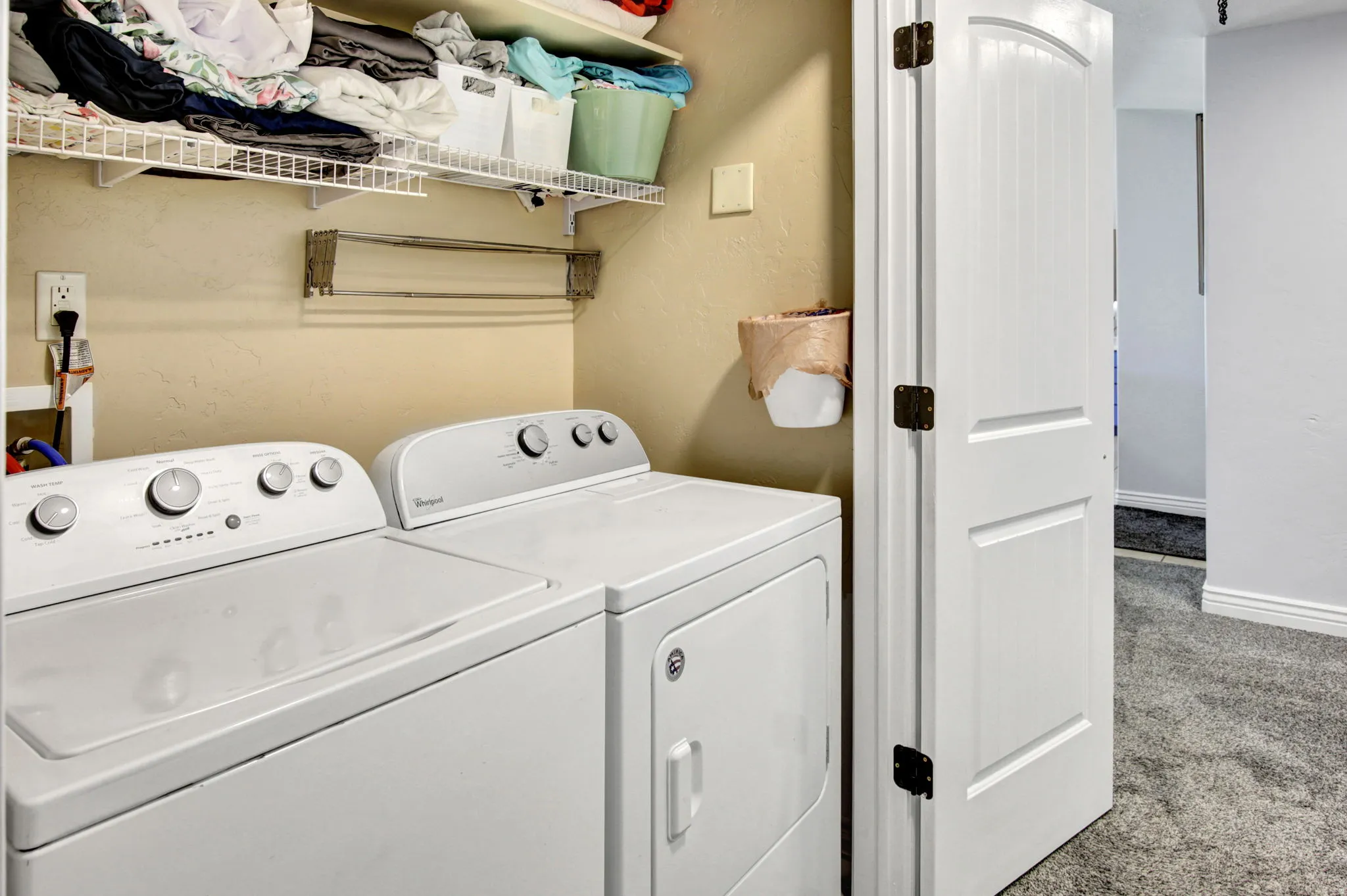 Dedicated laundry area featuring wire shelving for organization