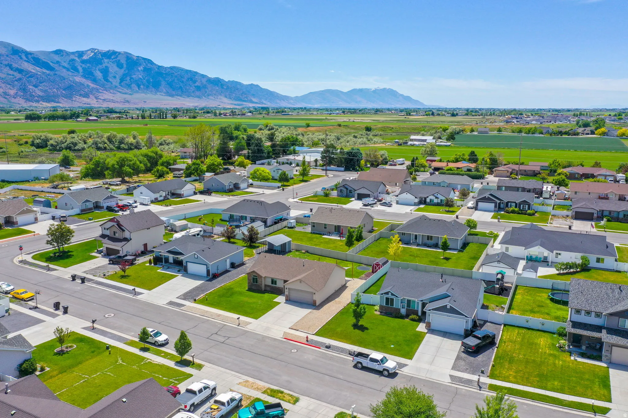 Aerial view of a residential neighborhood with single-story and two-story homes featuring attached garages