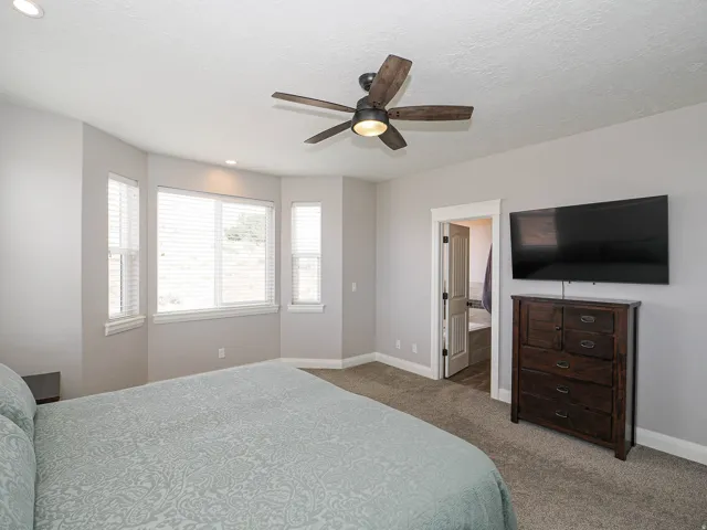 Bedroom featuring a bay window, recessed lighting, ceiling fan, and carpeted flooring