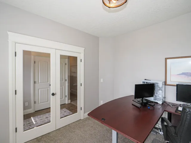 French doors with frosted glass panels, detailed trim, and dark hardware