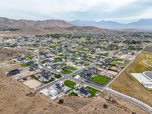 Expansive residential area featuring numerous single-family homes with dark roofs and varying architectural styles