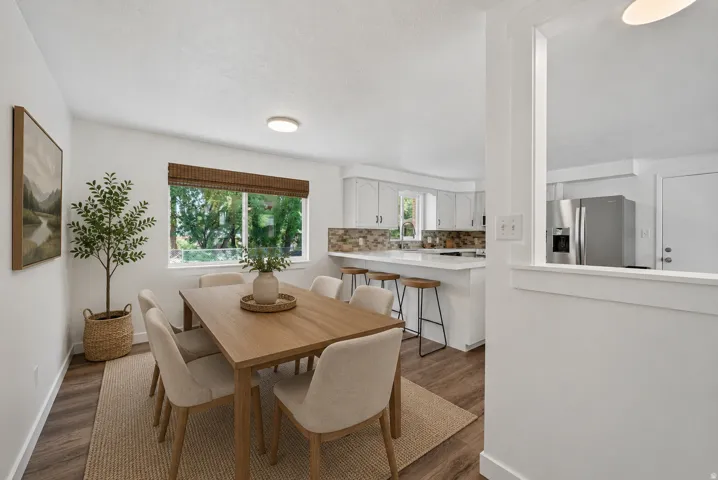 Dining area with wood-finish flooring and a large window