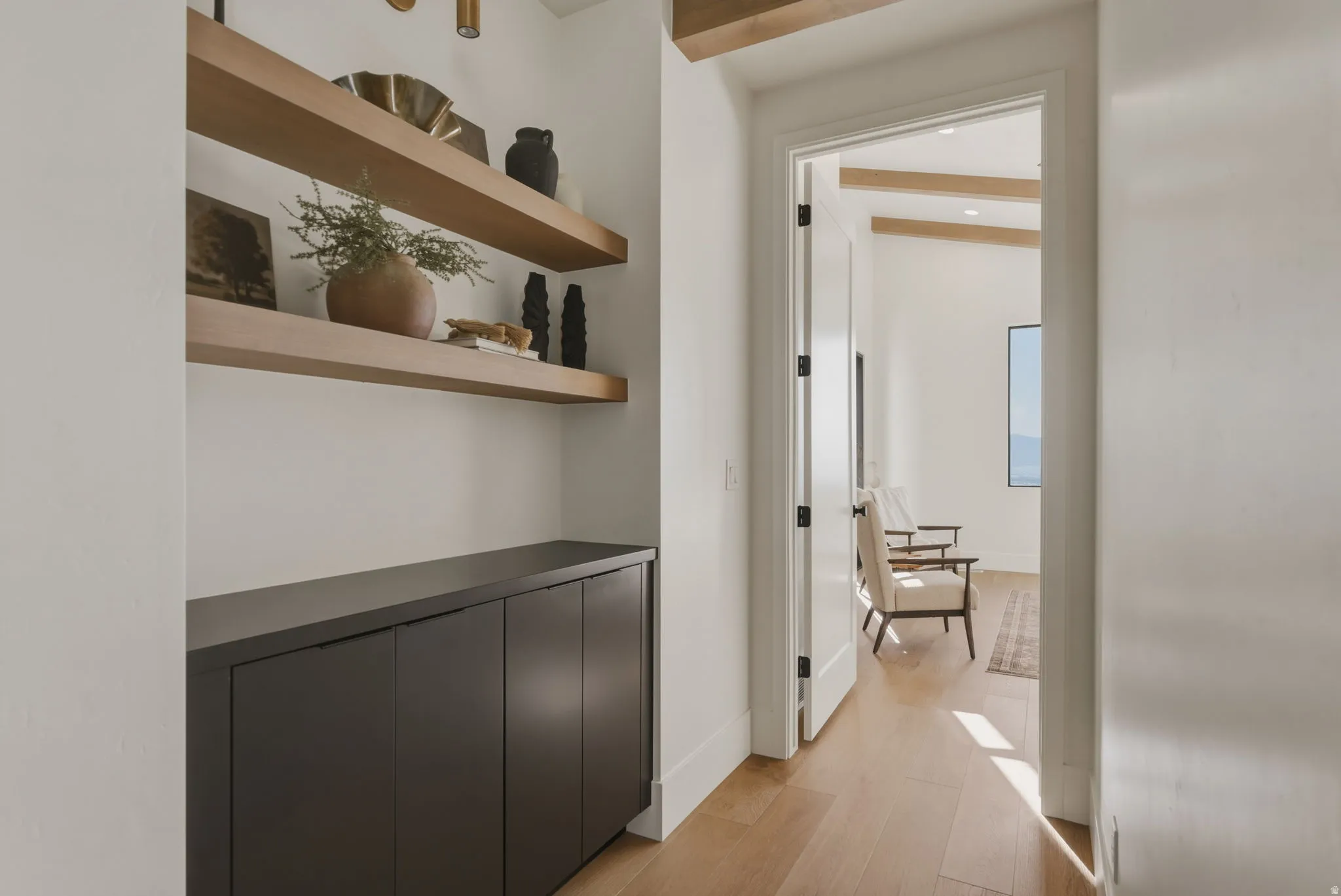 Built-in cabinetry with a dark countertop and floating wood shelves