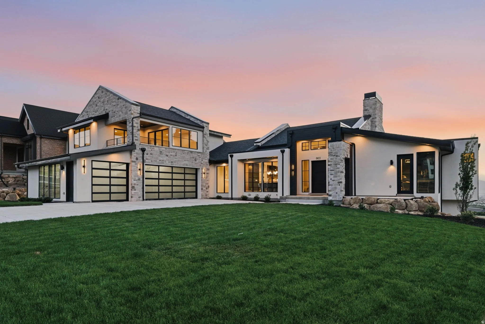Contemporary residence featuring a striking stone and stucco exterior