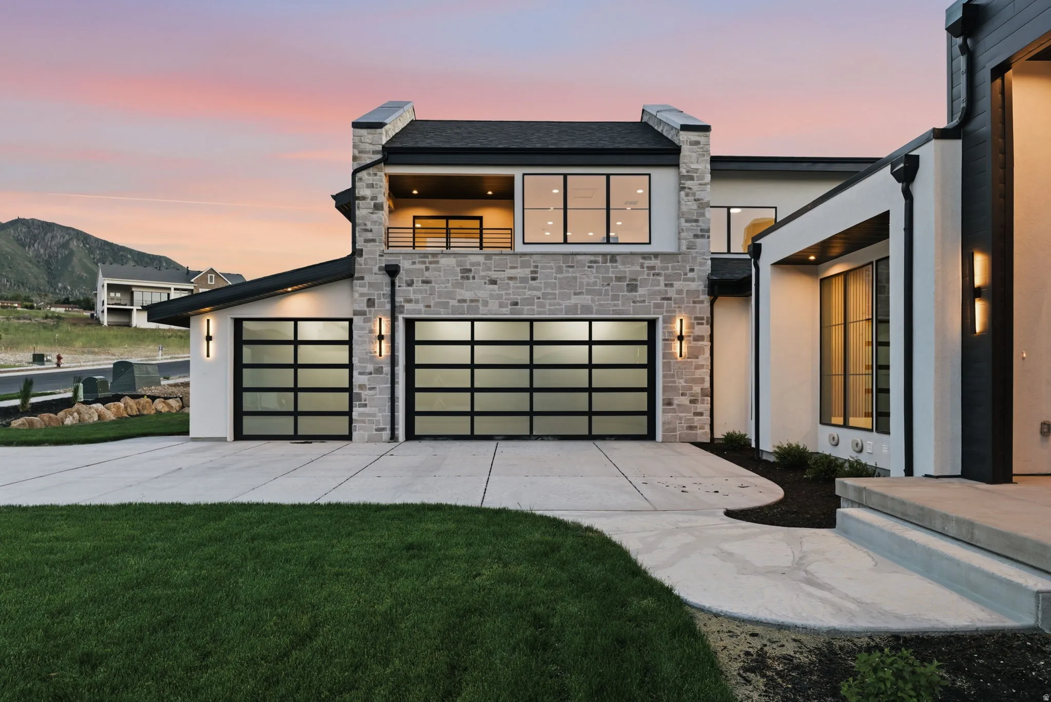Contemporary facade featuring stone veneer and smooth stucco finishes