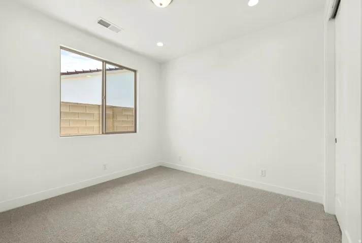 Room with neutral gray carpet and white walls