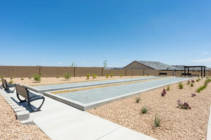 Recreational court area featuring two bocce ball courts with concrete borders and gravel surfaces