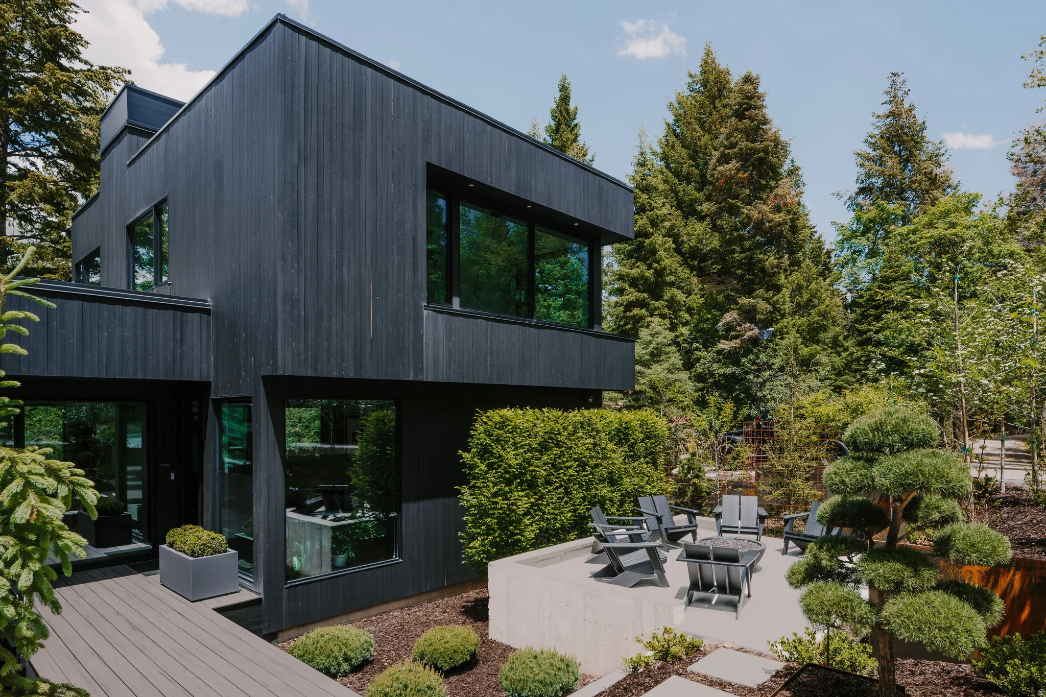 Modern exterior with dark wood-finish siding and expansive windows
