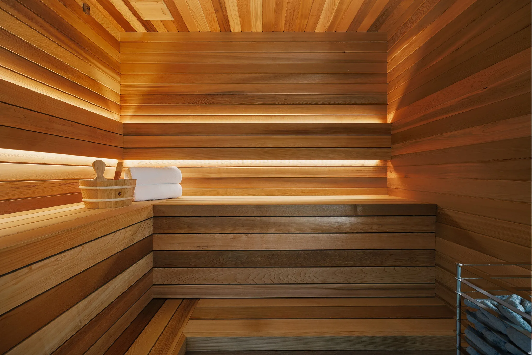 Interior sauna featuring wood-paneled walls and ceiling