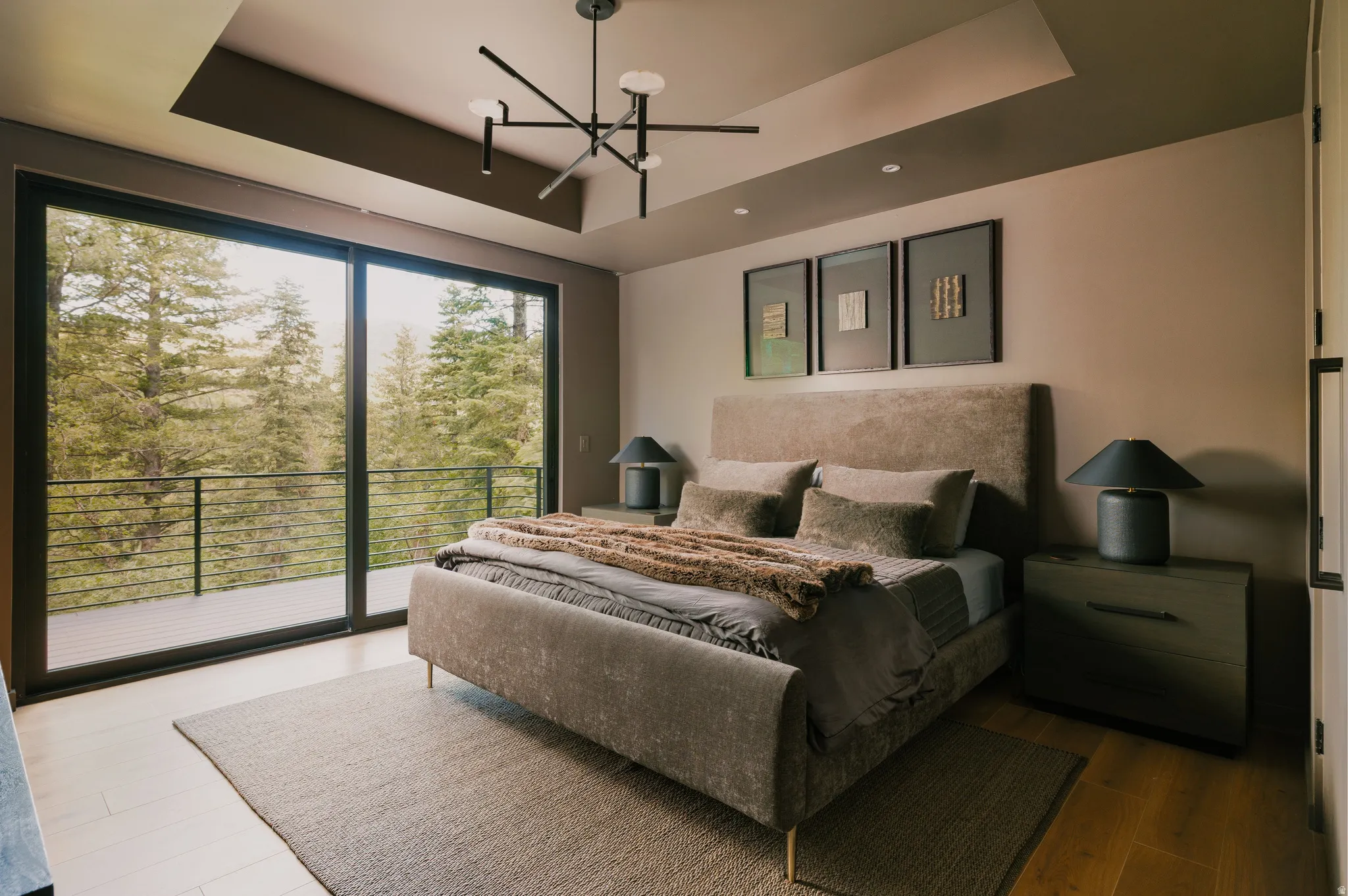 Expansive sliding glass doors opening to a private balcony with metal railing