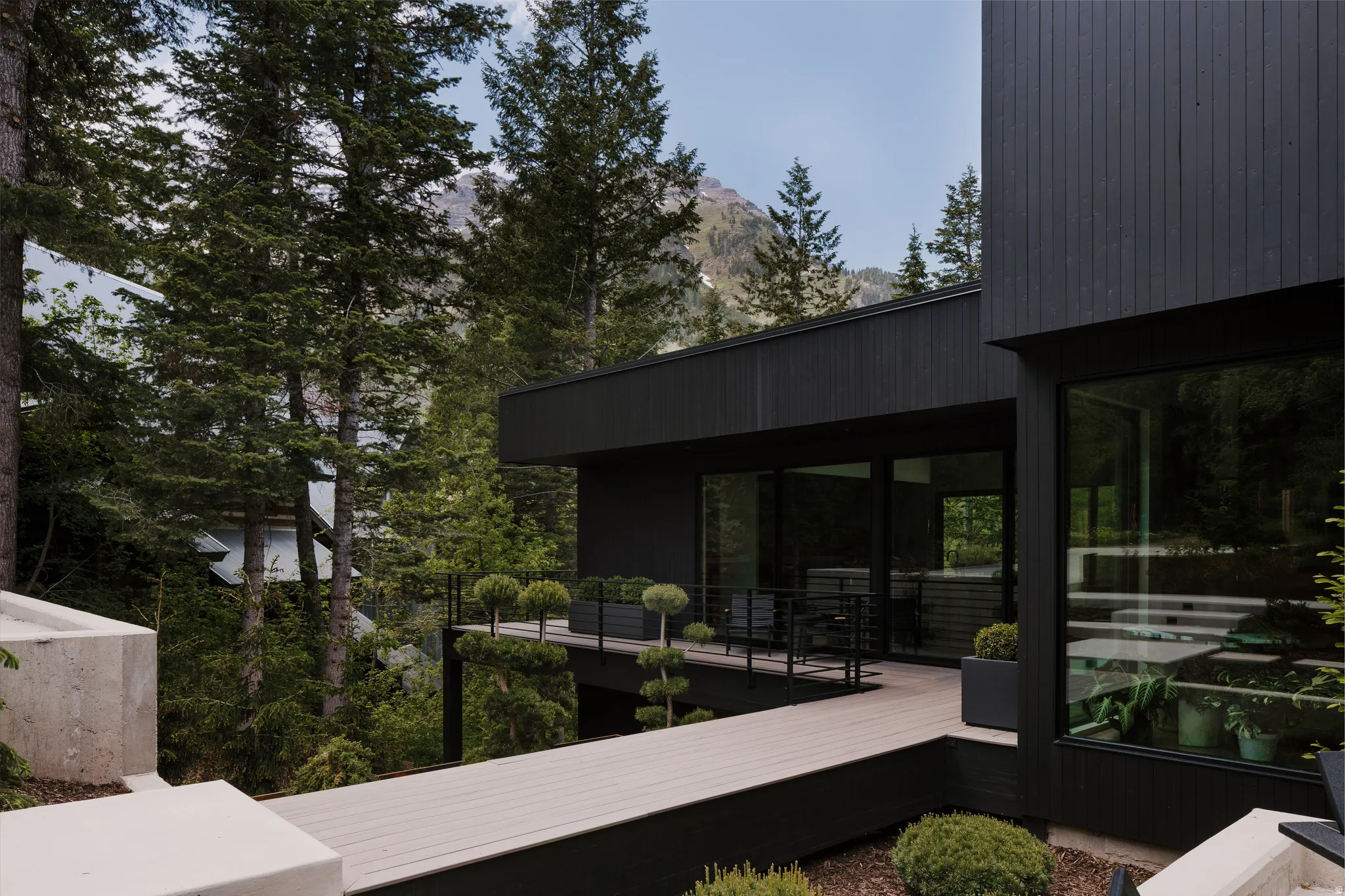 Modern exterior featuring black vertical siding and large windows
