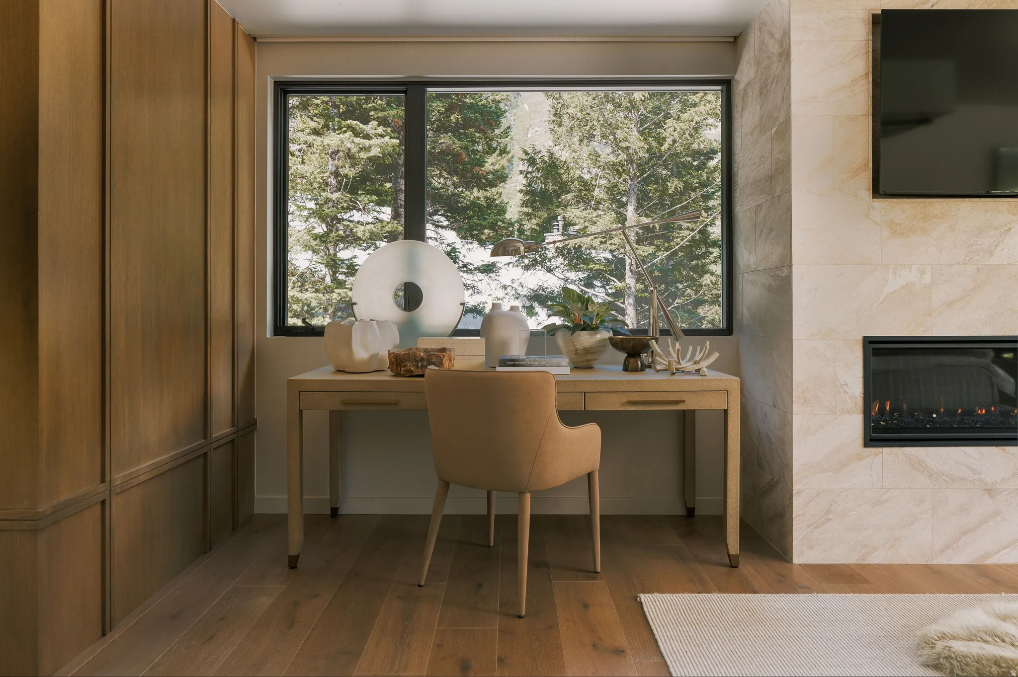 Wood-finish flooring throughout, complemented by a floor-to-ceiling wood-paneled wall